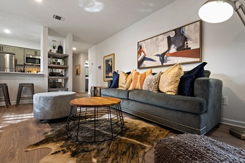 a living room with a gray couch and a round coffee table